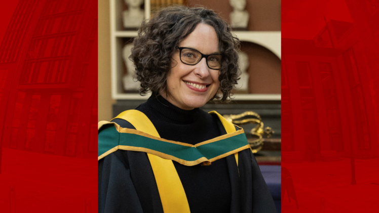 Woman with black curly hair wearing robes